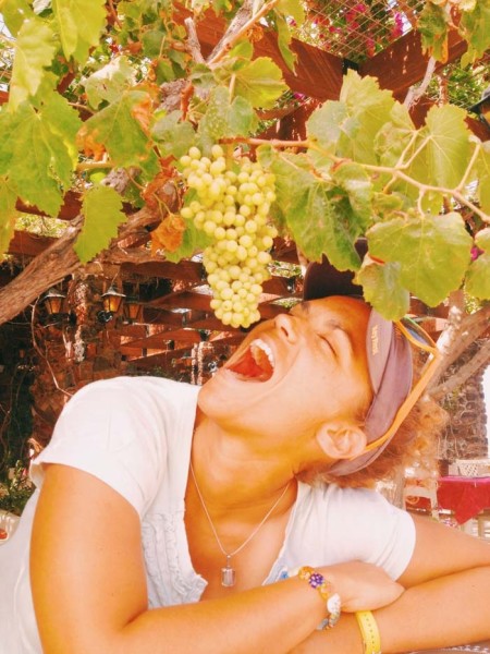Derika hanging out with grapes before crush.
