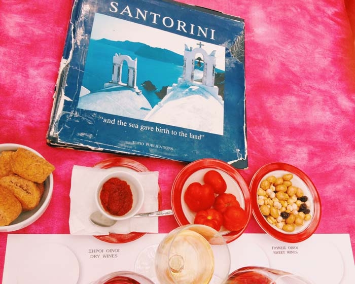 Our snack and wine flight complete with a Santorini book.